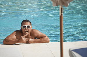 man in sunglasses enjoying his time in pool after pool tile restoration katy service